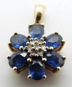 A 9ct gold pendant set with diamonds and sapphires