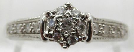 A 9ct white gold ring set with diamonds in a cluster,