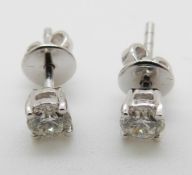 A pair of 18ct white gold earrings set with a diamond of approximately 0.