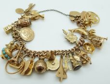 A 9ct gold charm bracelet with 20 yellow metal/ 9ct gold charms,