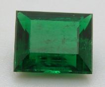 A rectangular cut apple green emerald of approximately 1.