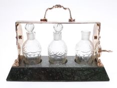 Small silver plate three-bottle tantallius on stone base,