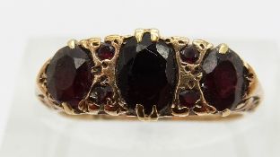 A 9ct gold ring set with garnets,
