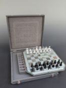 Swarovski Crystal cut glass chess set with clear and black pieces on mirrored board,