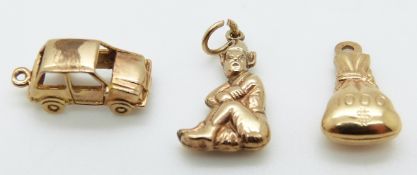 A 9ct gold charm/ pendant in the form of a car, a 9ct gold pixie charm and another 9ct gold charm,