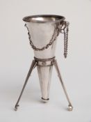 A white metal posy holder of trumpet form with three retractable legs,