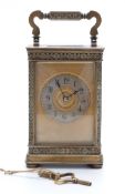 Late 19th / early 20thC brass carriage clock with floral and foliate design to case,