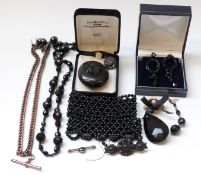 Victorian jet locket with a carved lily to the front, jet earrings, brooch,