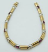 An 18ct bi-coloured gold tennis bracelet set with alternating rubies and diamonds, 17.