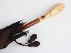 A 19thC/20thC parasol with carved ivory handle with vacant cartouche on hardwood stick,