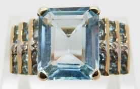 A 10k gold ring set with diamonds and blue topaz,