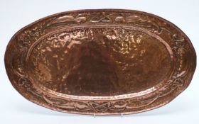 An oval Arts and Crafts style tray with embossed decoration W56cm