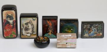 Six Russian lacquer boxes, some signed and a mother of pearl trinket box,