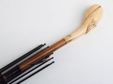 A 19thC/20thC parasol with carved ivory handle with vacant cartouche on hardwood stick,