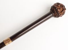 Late 19thC/20thC parasol the wooden handle with all around carving of inverted alternate dogs'