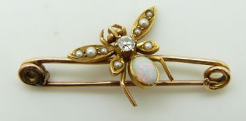 An Edwardian brooch in the form of an insect set with an opal, diamond and seed pearls.