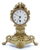 French 19thC gilt metal ormolu style mantel clock in balloon type case surmounted by a pair of