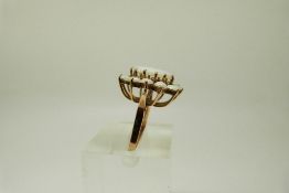 A yellow metal ring set with a cluster of opals, size Q, 4.9g.