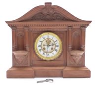 Late 19thC carved wooden mantel clock, the enamelled Roman dial with gilt bezels,