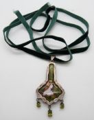 A white metal pendant in Art Nouveau style with female portrait after Rossetti