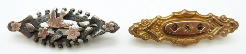 A 9ct gold brooch set with a diamond and two garnets (2.