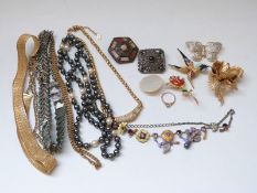 A 9ct gold ring set with a diamond, brooches including silver, hummingbird,