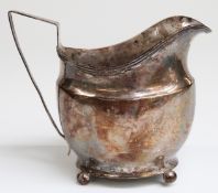 George III hallmarked silver helmet shaped cream jug raised on ball feet,