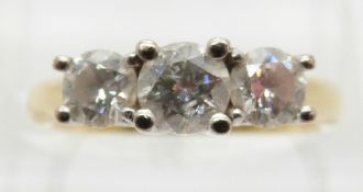 An 18ct gold ring set with three round cut diamonds, the centre diamond approximately 0.