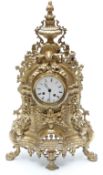 French 19thC ornate gilt brass mantel clock featuring a green man mask and urn finial,