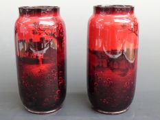 A pair of Royal Doulton flambé cylindrical vases,