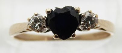 A 9ct gold ring set with a heart shaped sapphire and two diamonds,