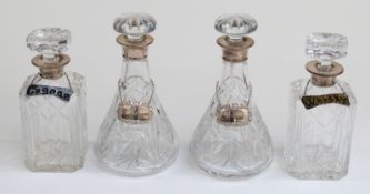 Two pairs of hallmarked silver mounted cut glass decanters with plated or enamel spirit tickets