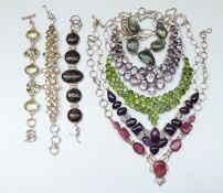 Four large white metal necklaces, one set with rubies,