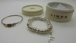 Links of London silver bracelet with letter F charm and a silver bangle set with pressed amber and