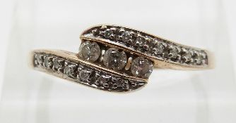 A 9ct gold ring set with diamonds in a twist setting,