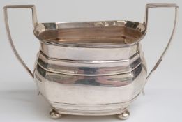 Hallmarked silver twin handled sugar bowl raised on four ball feet,
