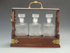 A brass mounted three bottle tantalus,