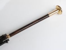 A late 19thC/20thC parasol with yellow metal and mother-of-pearl handle and collar impressed