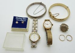 A silver bangle, gold plated bangle, two watches, silver coin,