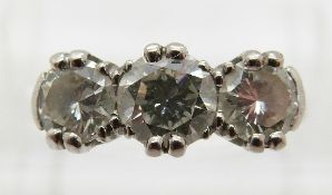 An 18ct white gold ring set with three round cut diamonds, the centre diamond approximately 0.
