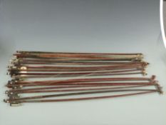 A collection of violin bows to include one stamped 'Japan' most with mother of pearl eyes and