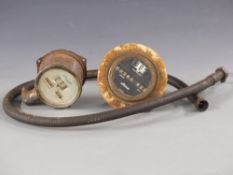 Two Stewart vintage car speedometers and a cable