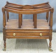 Mahogany Canterbury with drawer below, raised on brass castors,