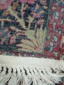 Persian rug with central design of birds in a tree, floral border and fringed ends, 185 x 131cm.