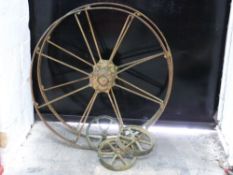 Pair of farm machinery or cart wheels and three smaller examples