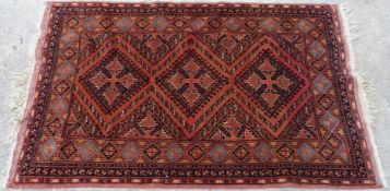 Afghan style rug with all over geometric decoration on burn orange ground,