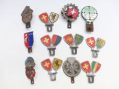 Twelve mainly Swiss interest car badges including Lugano etc