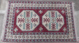 Fachralo style carpet with two central Memling type guls surrounded by boarders of multi-coloured