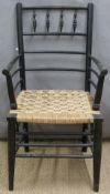 Ebonised rush seated armchair with turned details