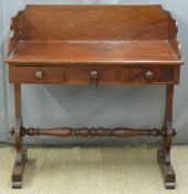 19thC mahogany three drawer side table or desk with shaped supports united by a turned stretcher,